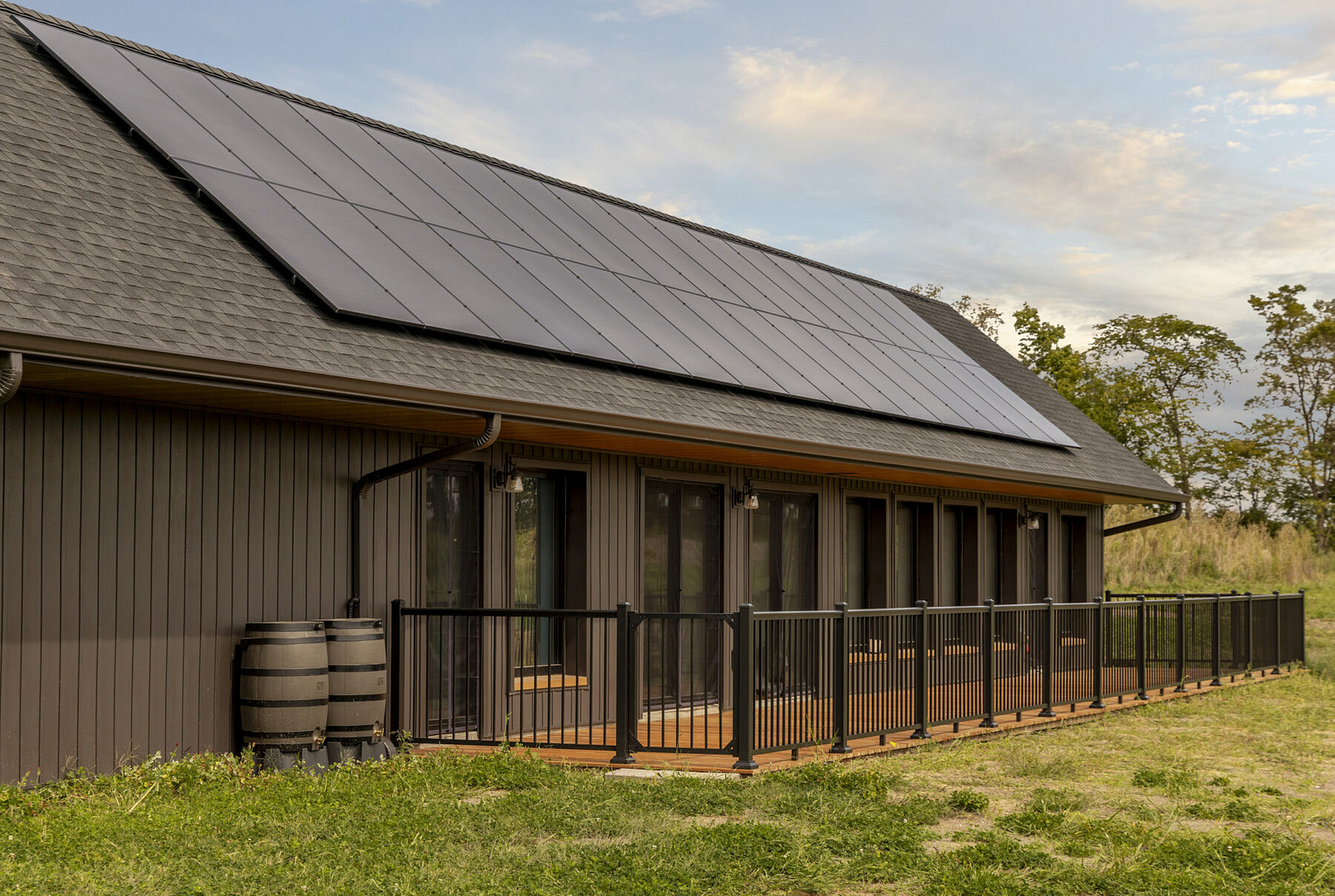 Home with solar panels amidst green landscape